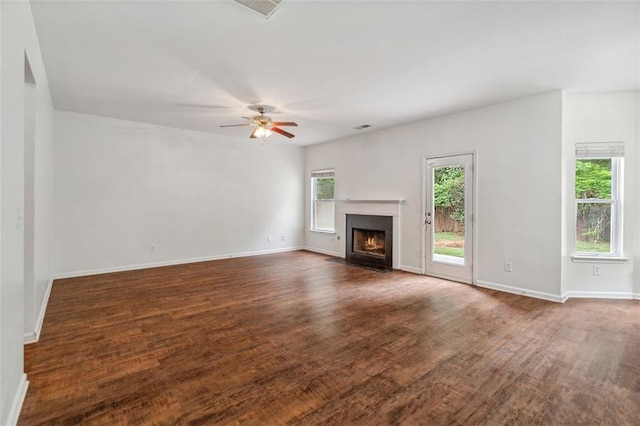 4515 Ambassador Way, Cumming, GA 30040 - unfurnished living room featuring a fireplace with flush hearth, ceiling fan, dark wood-type flooring, and baseboards