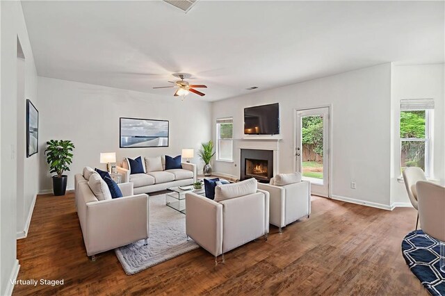 4515 Ambassador Way, Cumming, GA 30040 - living area with a lit fireplace, baseboards, and wood finished floors
