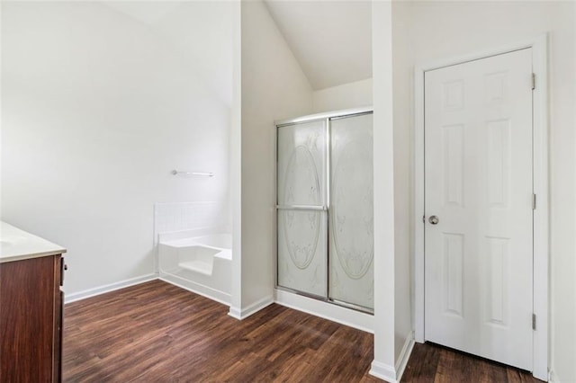 4515 Ambassador Way, Cumming, GA 30040 - full bath featuring wood finished floors, lofted ceiling, a shower stall, a bath, and baseboards