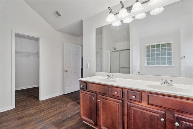 4515 Ambassador Way, Cumming, GA 30040 - bathroom with a shower stall, lofted ceiling, wood finished floors, baseboards, and double vanity