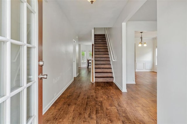 4515 Ambassador Way, Cumming, GA 30040 - foyer entrance featuring stairs, wood finished floors, a chandelier, and a wainscoted wall