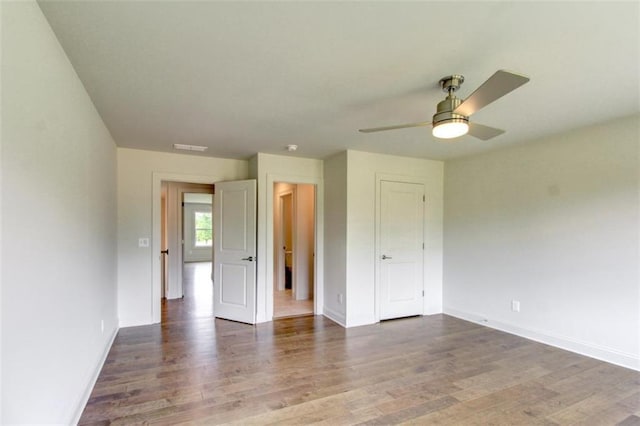 3065 Reserve Ct SW, Conyers, GA 30094 - spare room with wood finished floors, a ceiling fan, and baseboards