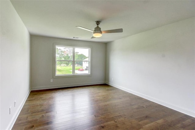 3065 Reserve Ct SW, Conyers, GA 30094 - unfurnished room with dark wood finished floors, ceiling fan, and baseboards
