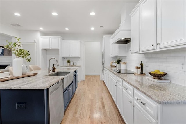 kitchen featuring white cabinetry, light hardwood / wood-style flooring, stainless steel dishwasher, custom exhaust hood, and black electric stovetop