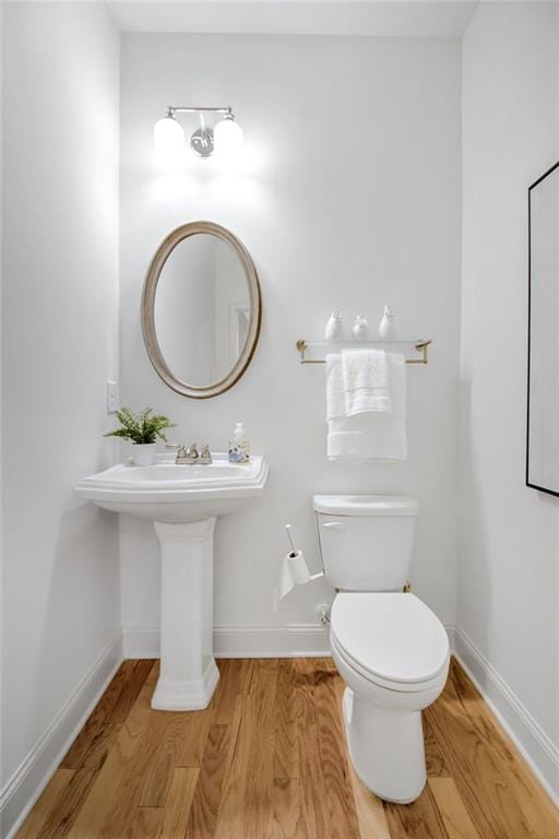 bathroom with wood-type flooring and toilet