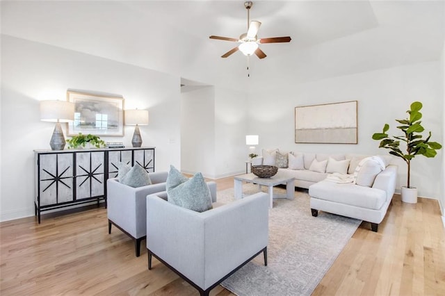 living room featuring ceiling fan and light hardwood / wood-style flooring