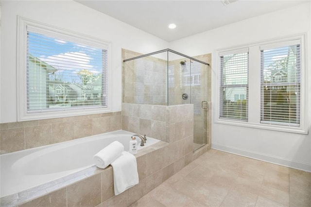 bathroom featuring independent shower and bath