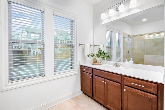 bathroom with an enclosed shower, tile patterned floors, a healthy amount of sunlight, and vanity