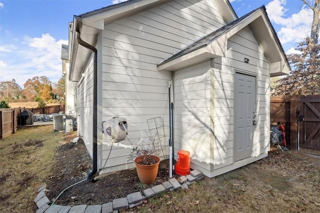 view of side of property with cooling unit, a gate, and fence