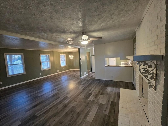 unfurnished living room with dark wood-type flooring, ceiling fan, a fireplace, and a textured ceiling