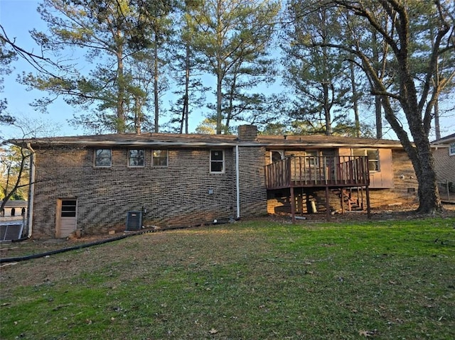 rear view of house featuring central AC, a yard, and a deck