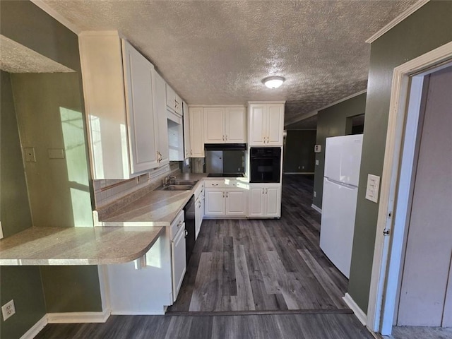 kitchen featuring oven, white cabinets, dark hardwood / wood-style flooring, kitchen peninsula, and white fridge