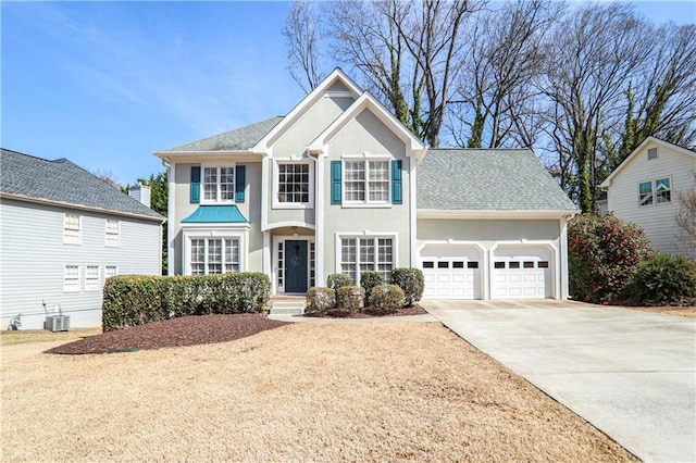 view of front of house featuring stucco siding, driveway, a shingled roof, and a garage