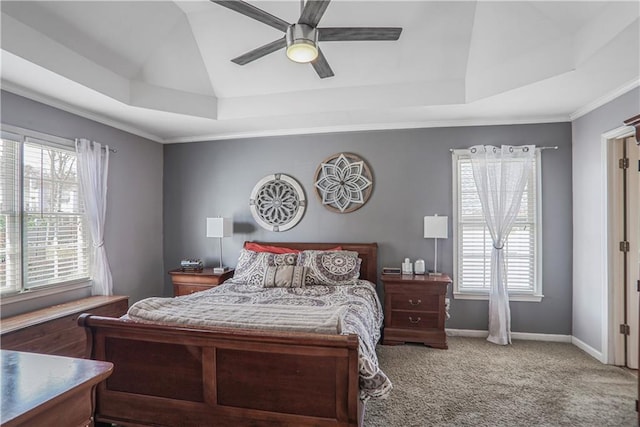 carpeted bedroom with baseboards, a raised ceiling, and a ceiling fan