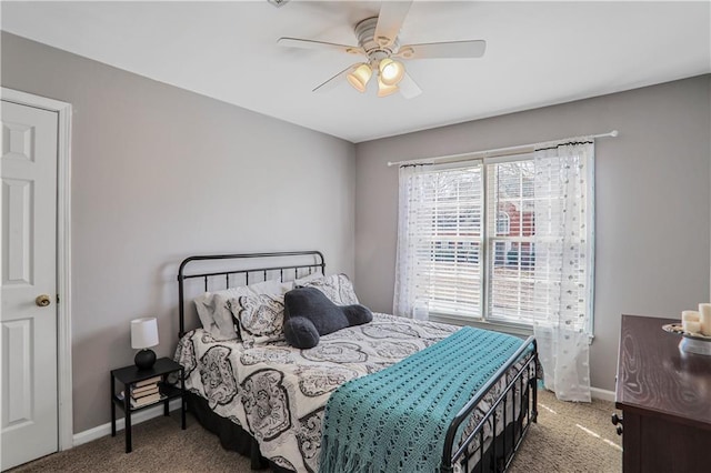 carpeted bedroom featuring baseboards and ceiling fan