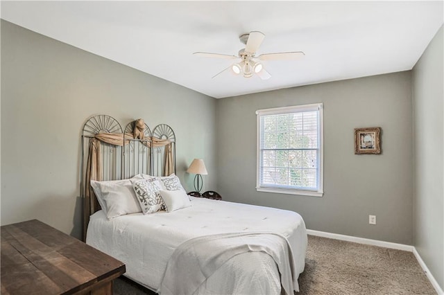 bedroom featuring a ceiling fan, carpet, and baseboards