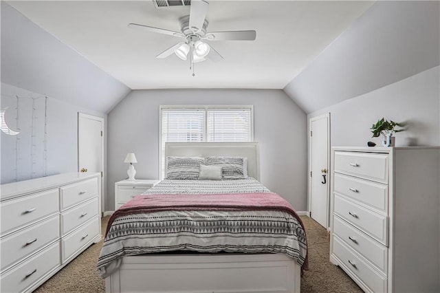 carpeted bedroom with visible vents, a ceiling fan, and lofted ceiling