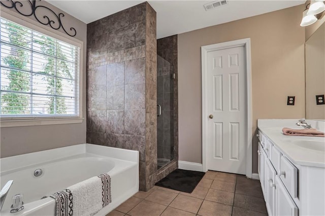 full bath with visible vents, a garden tub, a stall shower, tile patterned floors, and vanity