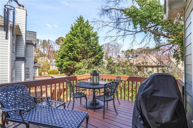 deck featuring a grill and outdoor dining space