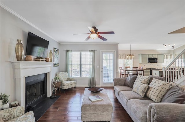 living area featuring stairway, baseboards, a fireplace with flush hearth, ornamental molding, and dark wood-type flooring