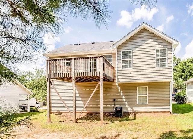 back of house with a wooden deck and a yard