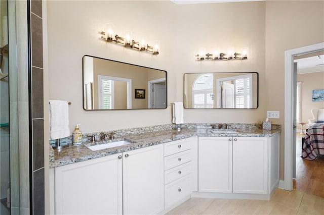 bathroom featuring a sink and double vanity
