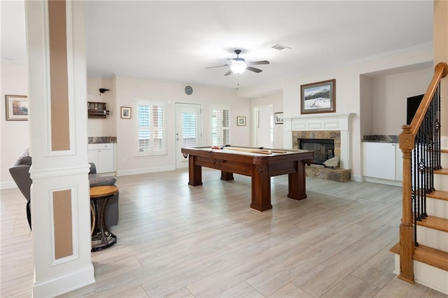 game room with light wood-style flooring, visible vents, a fireplace with raised hearth, ceiling fan, and pool table