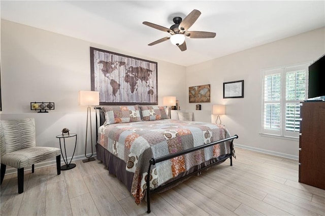 bedroom with light wood-style flooring, baseboards, and ceiling fan