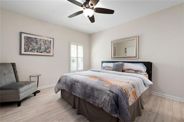 bedroom with baseboards, a ceiling fan, and wood finished floors