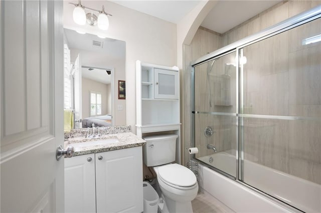 ensuite bathroom featuring toilet, visible vents, combined bath / shower with glass door, vanity, and connected bathroom