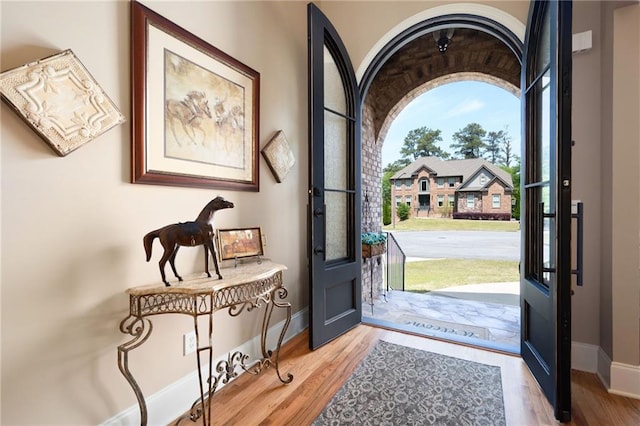 foyer featuring light wood finished floors and baseboards