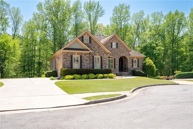 view of front of property featuring a front lawn and brick siding