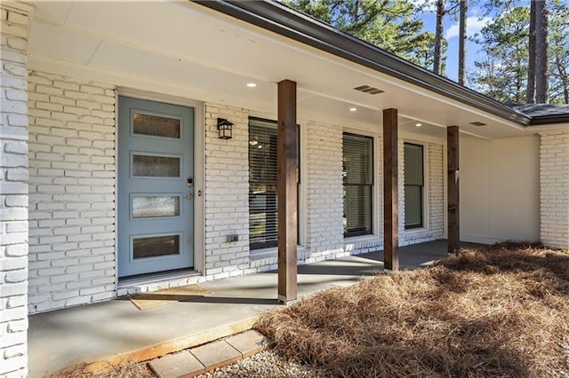 4178 Castle Pines Ct, Tucker, GA 30084 - view of exterior entry with brick siding and a porch
