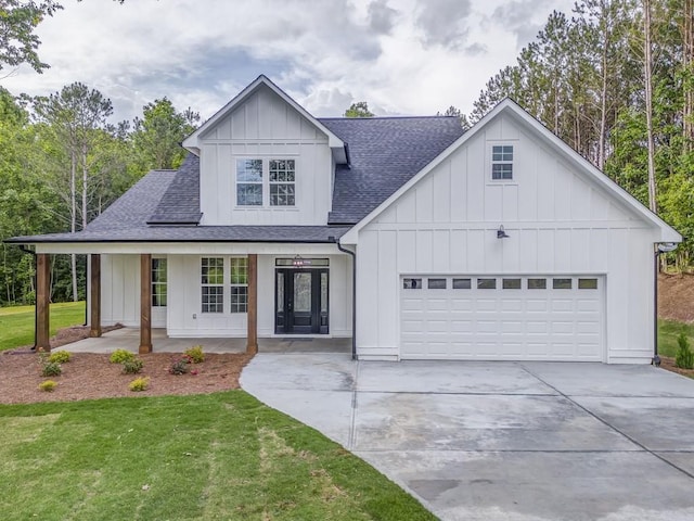 961 Goat Rd NW, Resaca, GA 30735 - modern farmhouse featuring a shingled roof, board and batten siding, an attached garage, concrete driveway, and a front yard