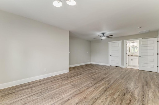 961 Goat Rd NW, Resaca, GA 30735 - unfurnished living room featuring light wood-type flooring, baseboards, a ceiling fan, a chandelier, and a sink