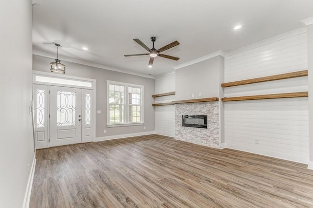 961 Goat Rd NW, Resaca, GA 30735 - unfurnished living room featuring wood finished floors, ceiling fan, a stone fireplace, baseboards, and ornamental molding