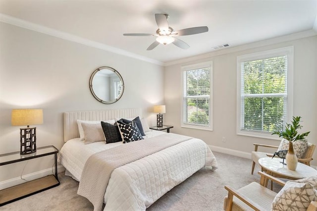 carpeted bedroom with ceiling fan and ornamental molding