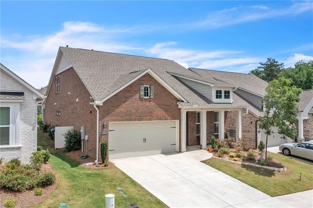 view of front of house featuring brick siding, roof with shingles, a garage, driveway, and a front lawn