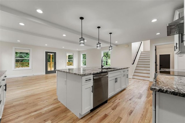 kitchen with plenty of natural light, sink, an island with sink, white cabinets, and stainless steel dishwasher