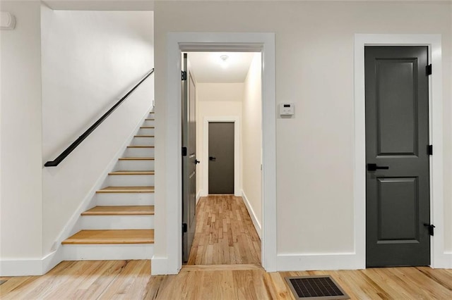 stairs with hardwood / wood-style flooring