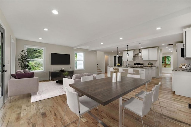 dining area with light hardwood / wood-style floors and sink