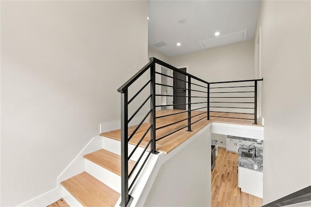 staircase with hardwood / wood-style flooring