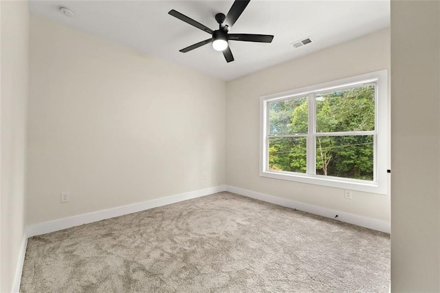 empty room with ceiling fan and light colored carpet