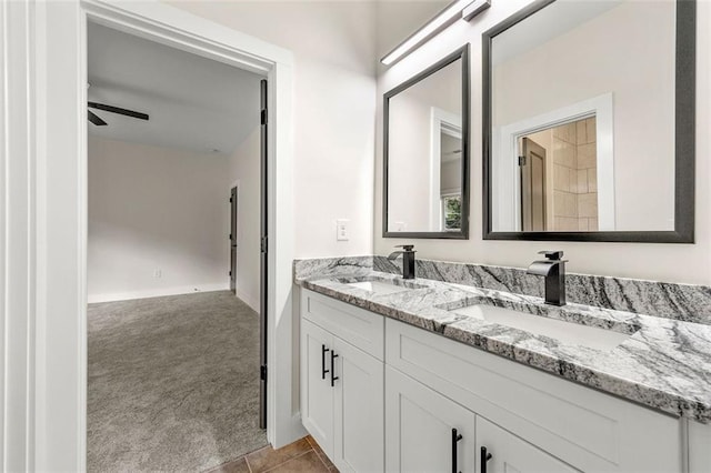 bathroom with ceiling fan, vanity, and tile patterned flooring