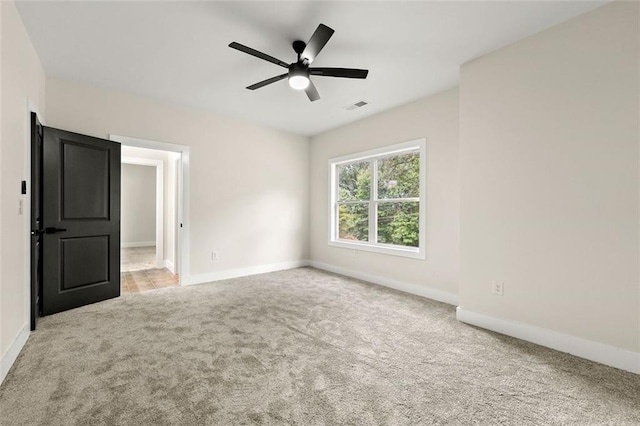 unfurnished bedroom featuring light carpet and ceiling fan