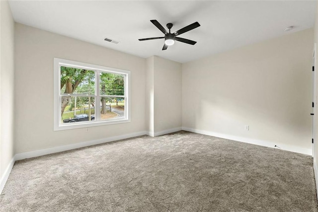 carpeted empty room featuring ceiling fan