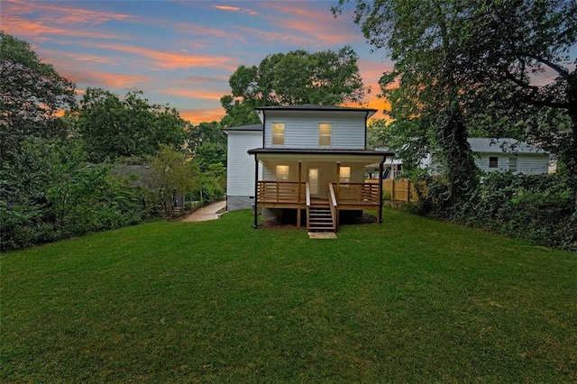 back house at dusk with a yard