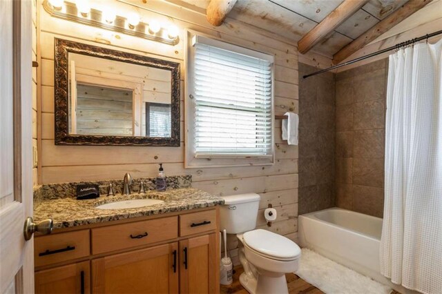 full bathroom with shower / bath combo with shower curtain, wood walls, toilet, and wooden ceiling