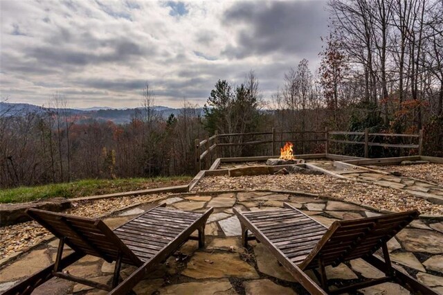 view of patio featuring a mountain view and an outdoor fire pit