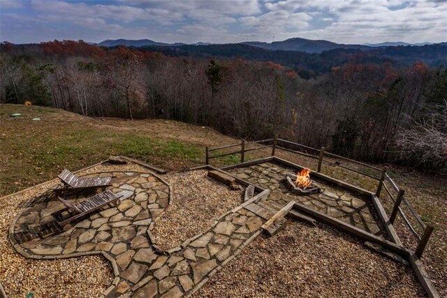 view of yard with a mountain view and a fire pit